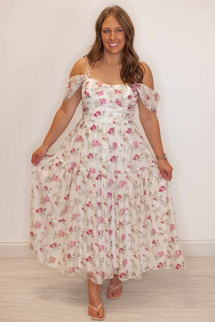 Women’s Off white and pink floral print event dress, closeup view. 