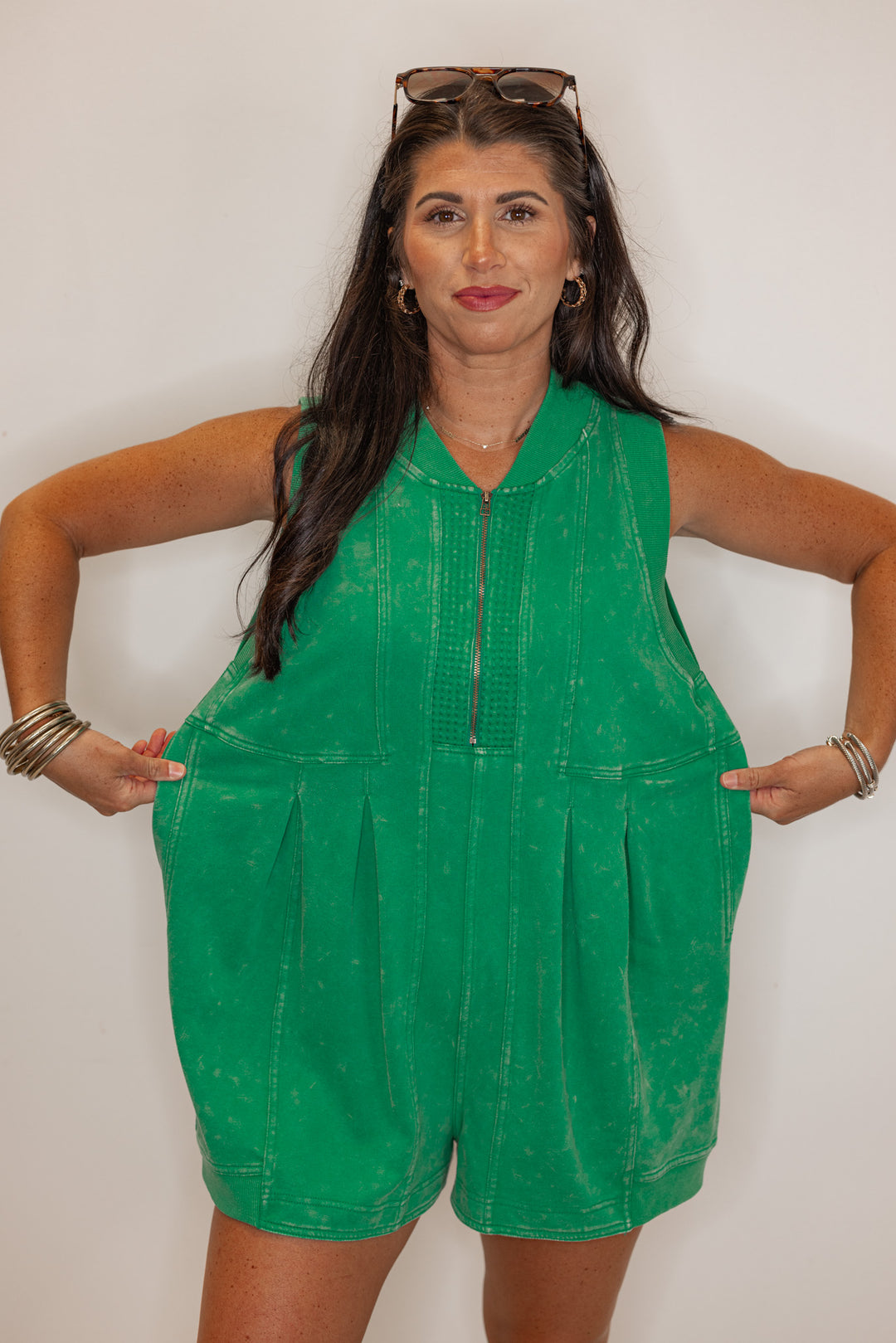 Women’s emerald green, easy fitting romper, showing the oversized fit. 
