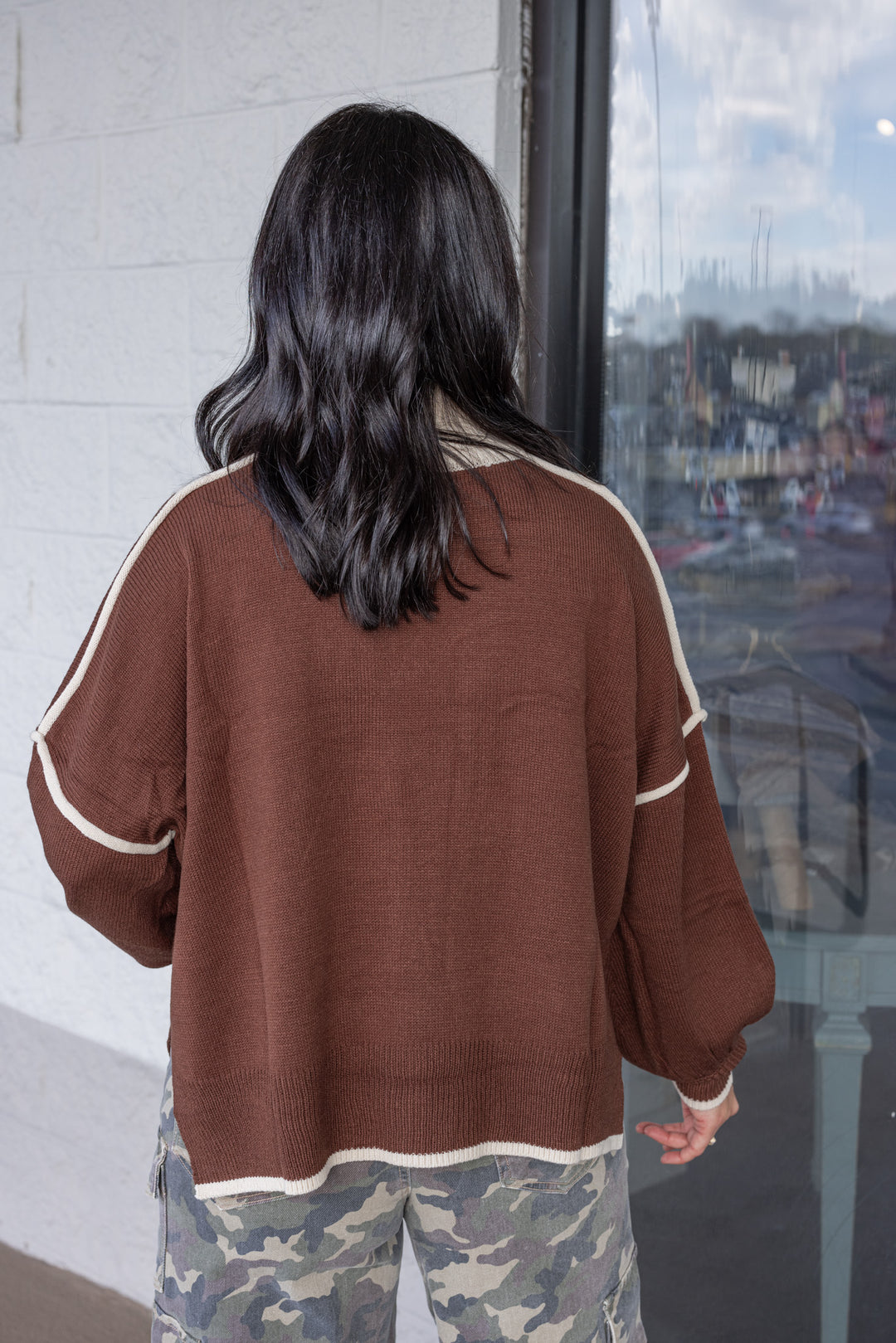 Women's brown knit sweater with cream trim and a zipper bodice by She + Sky showing up close back view