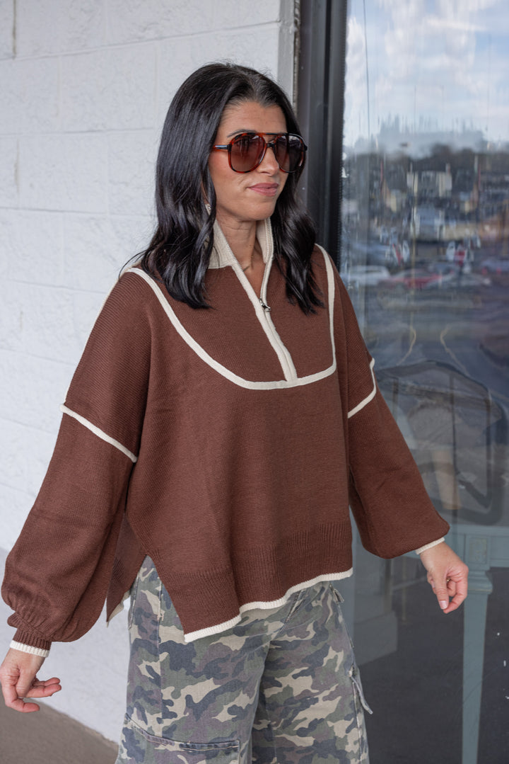 Women's brown knit sweater with cream trim and a zipper bodice by She + Sky showing up close, slightly angled view