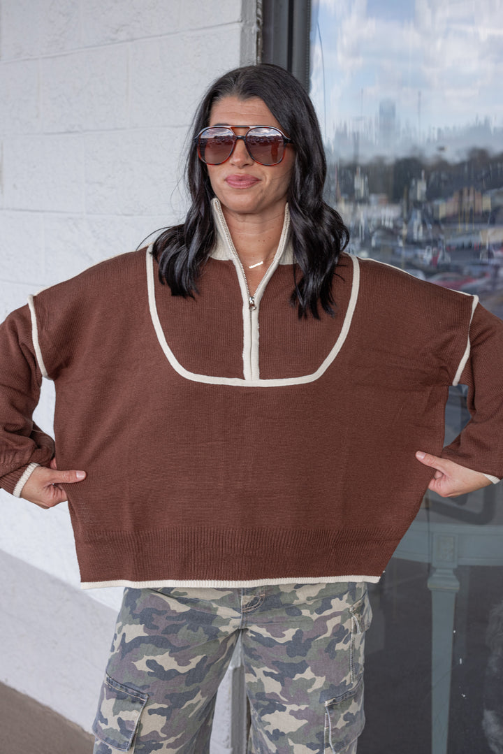 Women's brown knit sweater with cream trim and a zipper bodice by She + Sky showing true to size fit
