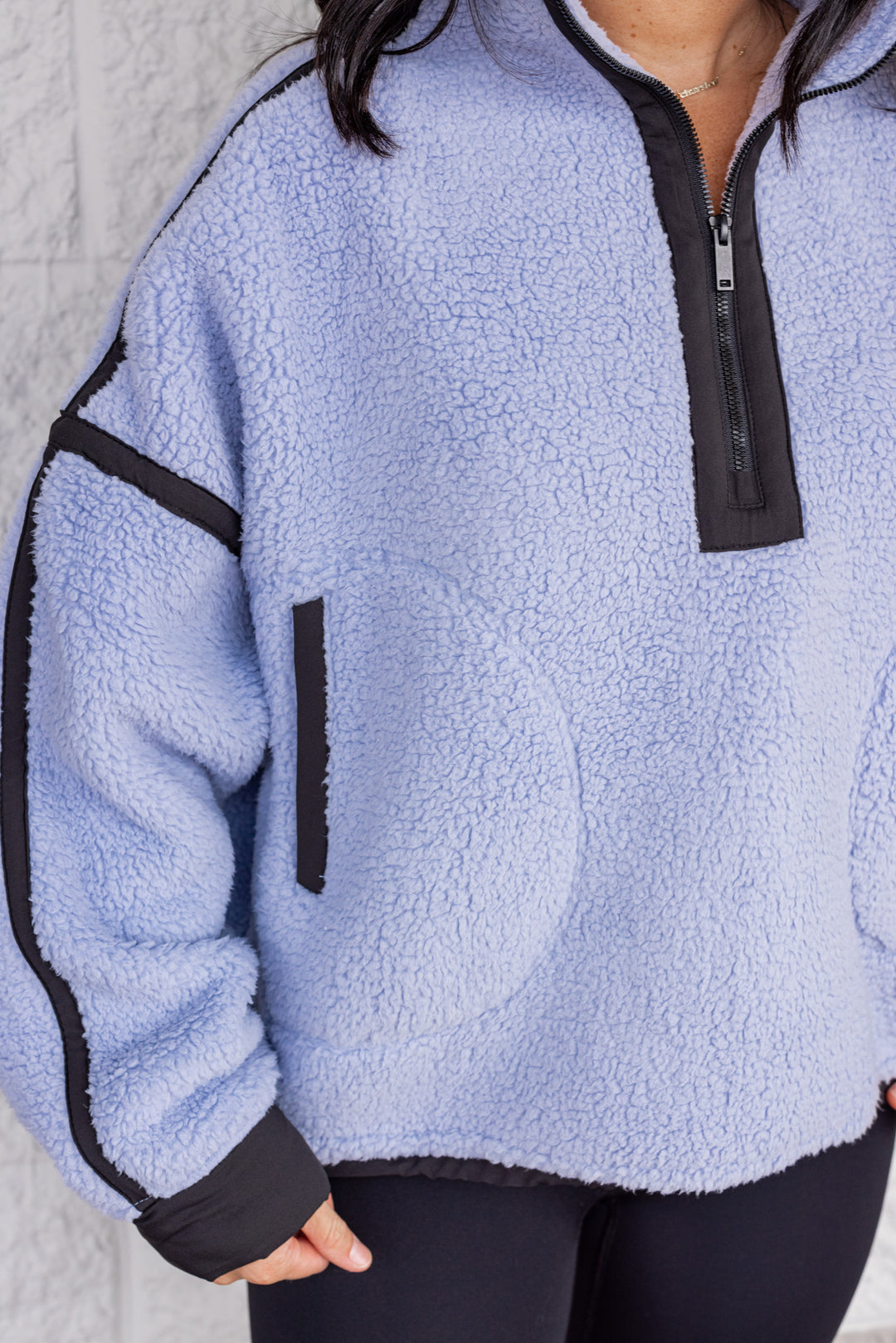 Women's bluish lavender sherpa quarter zip pullover jacket by Rae Mode showing black trim details