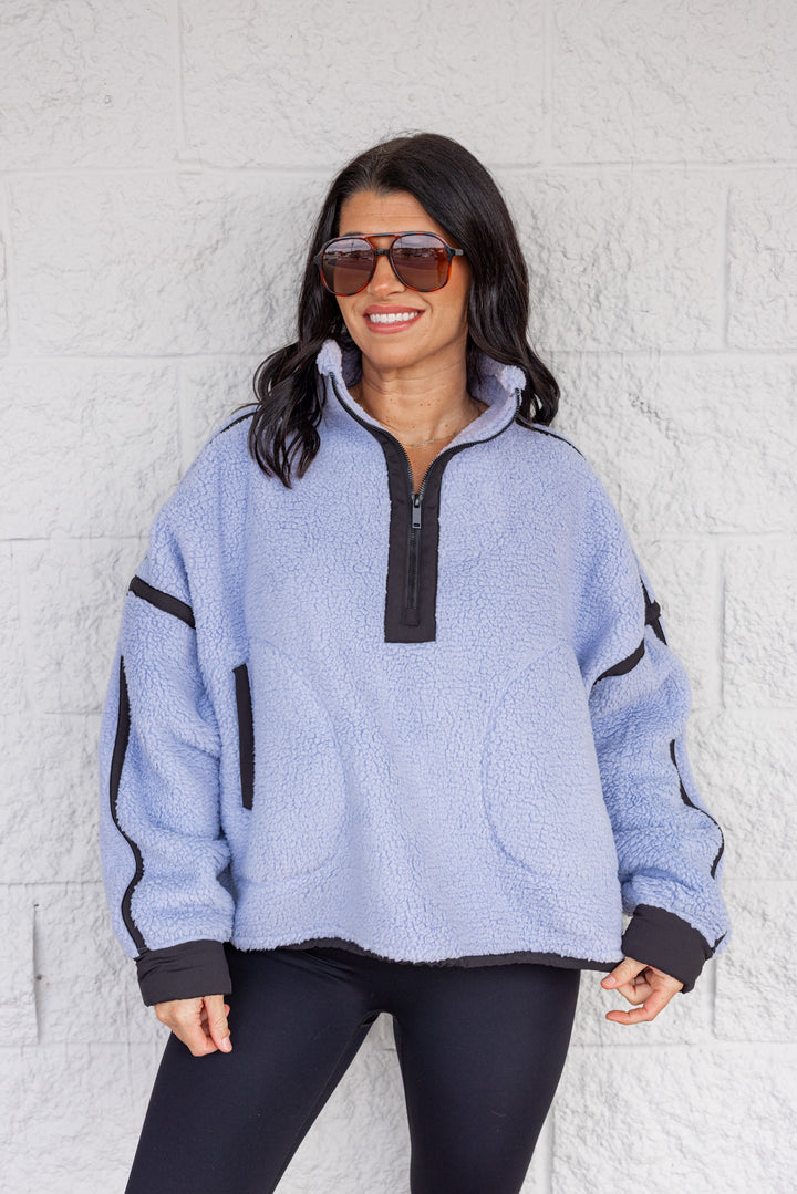 Women's bluish lavender sherpa quarter zip pullover jacket with black trim by Rae Mode