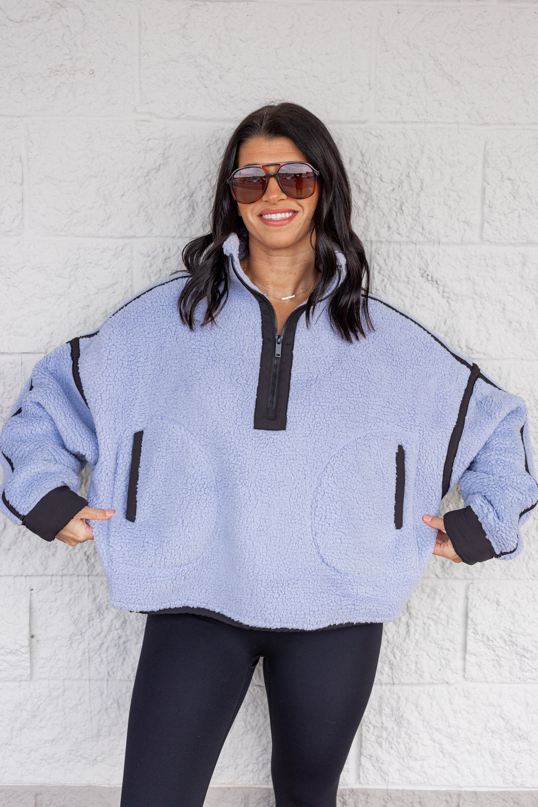 Women's bluish lavender sherpa quarter zip pullover jacket with black trim by Rae Mode showing relaxed fit