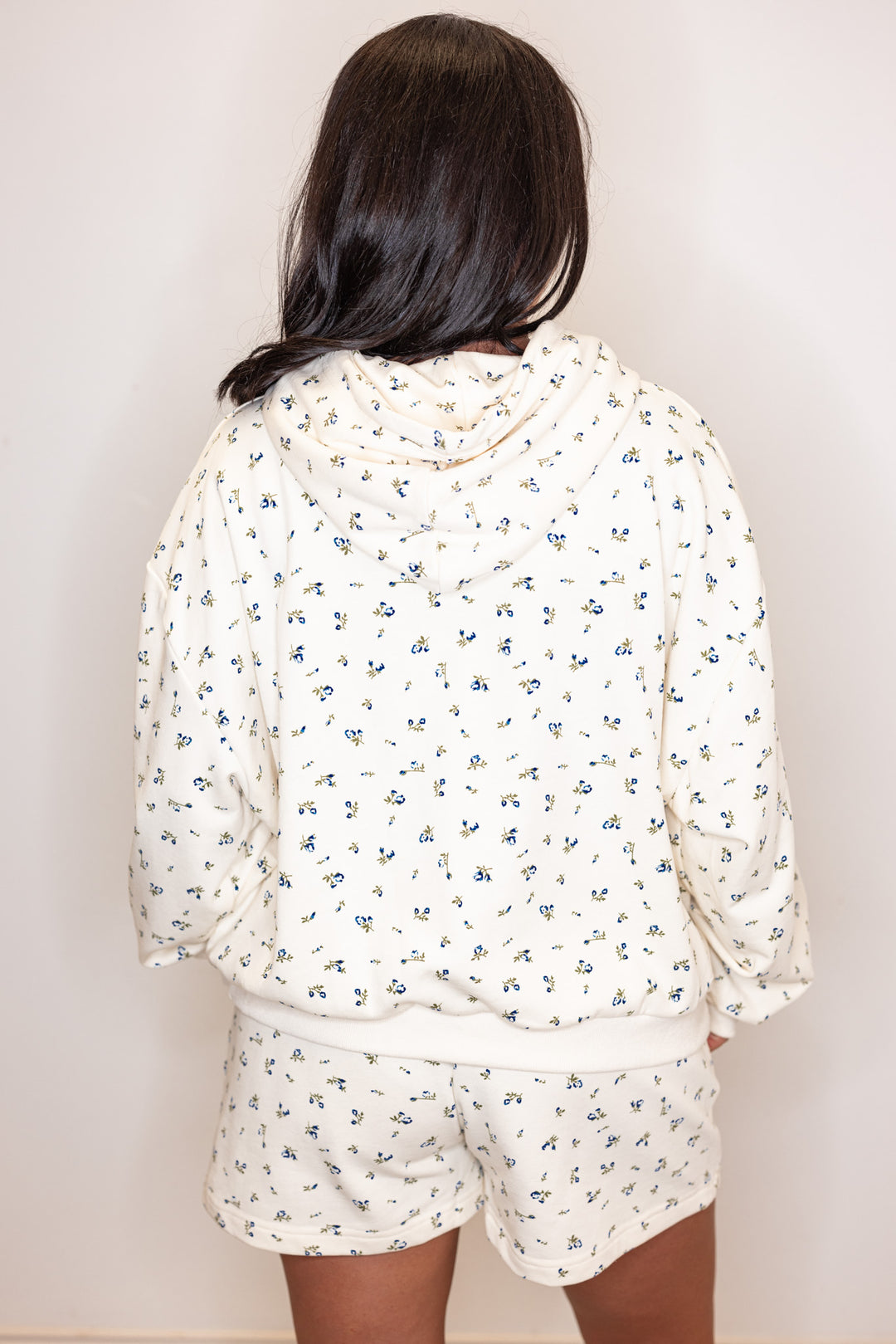 Women's cream french terry knit hooded top with blue floral print by Wishlist showing back view