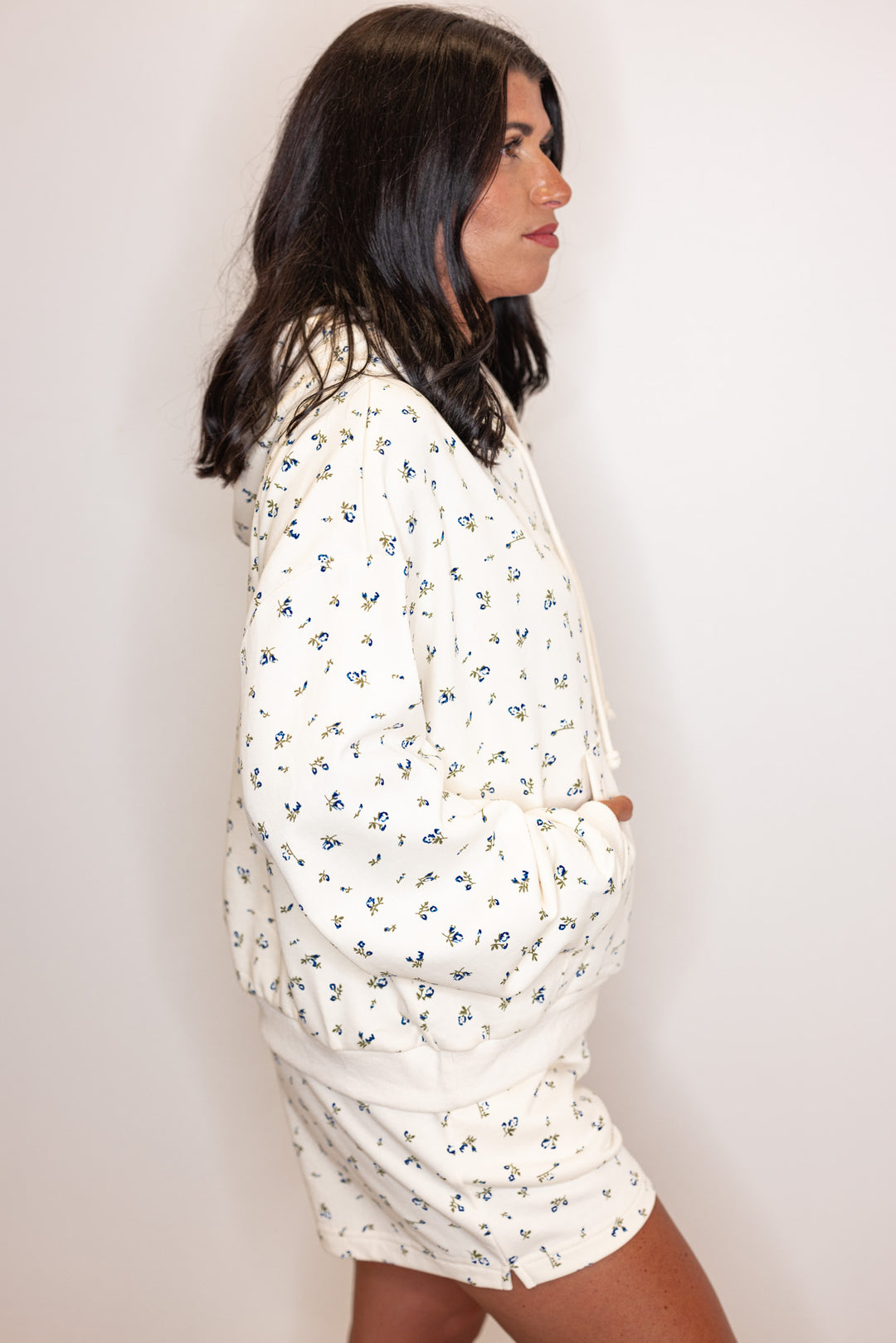 Women's cream french terry knit hooded top with blue floral print by Wishlist showing side view