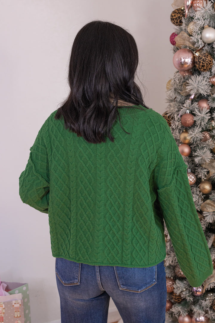 Women's cable knit button front sweater cardigan in forest green with ribbed trim by Entro showing up close back view