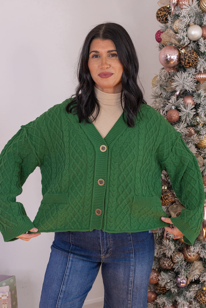 Women's cable knit button front sweater cardigan in forest green with ribbed trim by Entro showing semi-cropped length