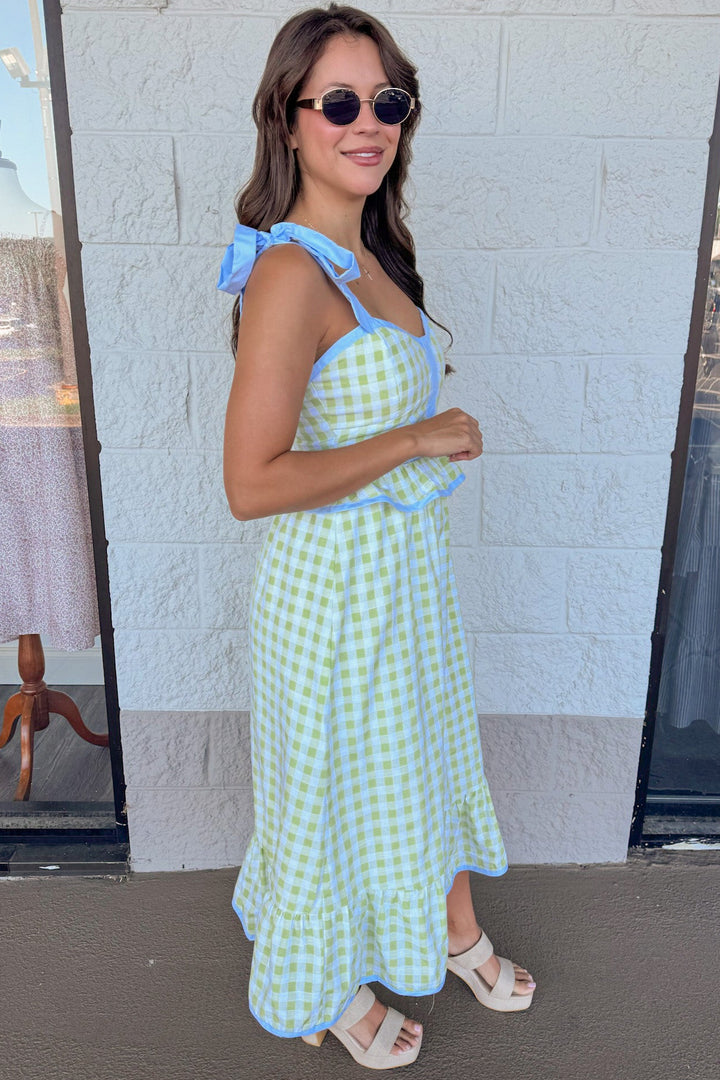 honeydew green gingham print with light blue trim details peplum style midi dress with self tie shoulder straps