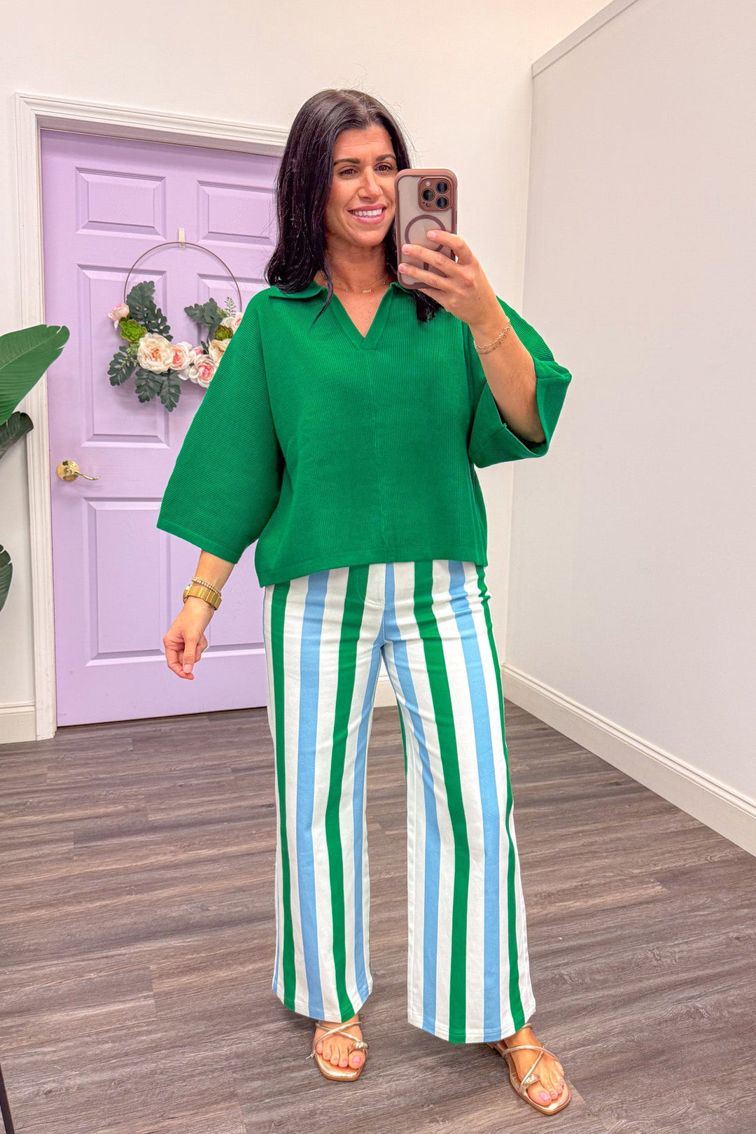 Women's summer green sweater top paired with green and blue striped pants