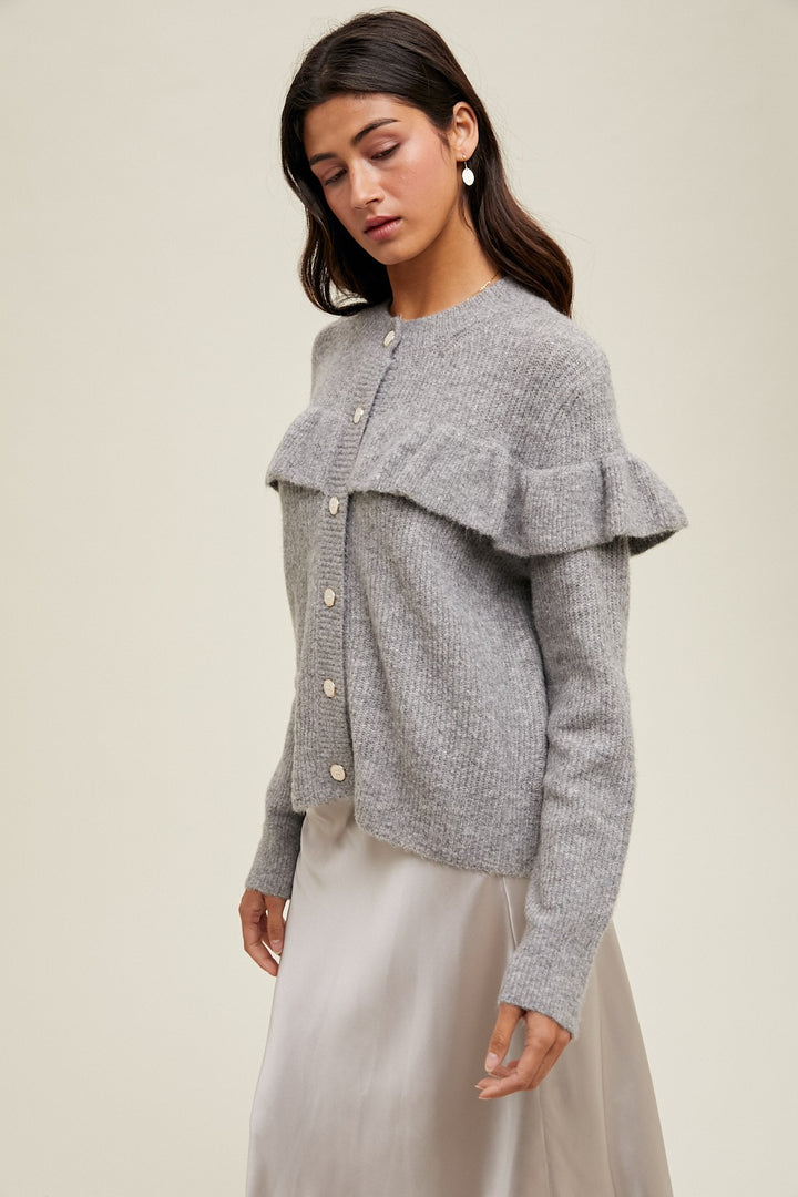 Women's grey knit sweater with a ruffle across the front chest and back shoulders by Wishlist showing side view