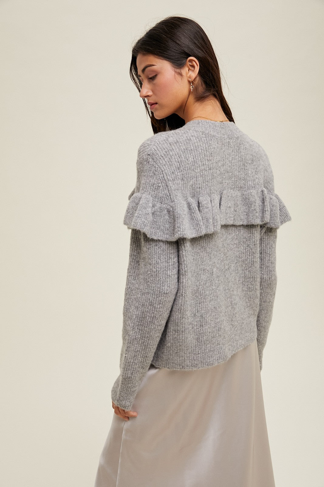 Women's grey knit sweater with a ruffle across the front chest and back shoulders by Wishlist showing back view