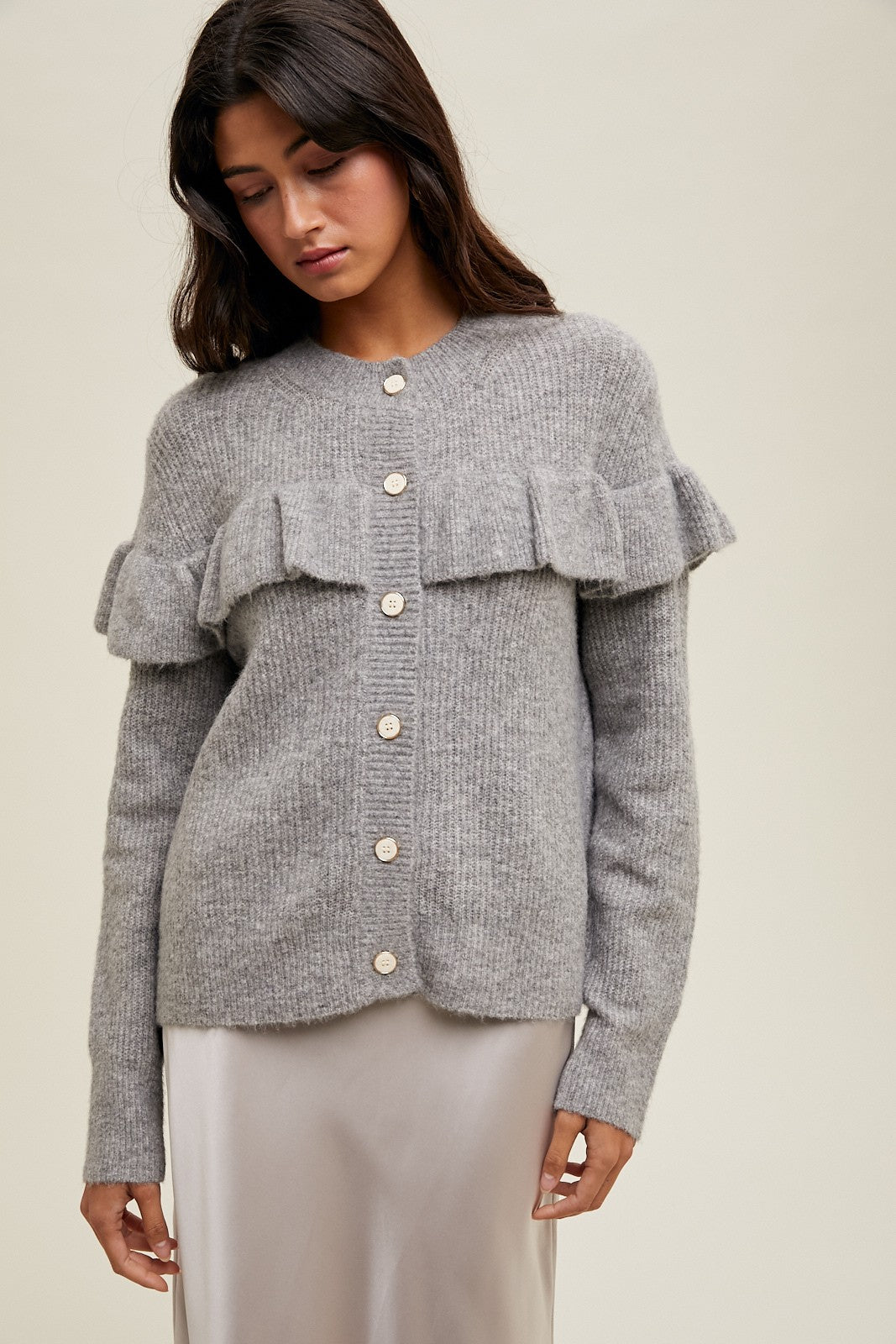 Women's grey knit sweater with a ruffle across the front chest and back shoulders by Wishlist