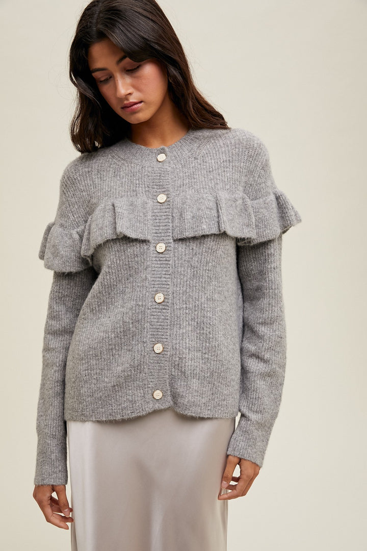 Women's grey knit sweater with a ruffle across the front chest and back shoulders by Wishlist