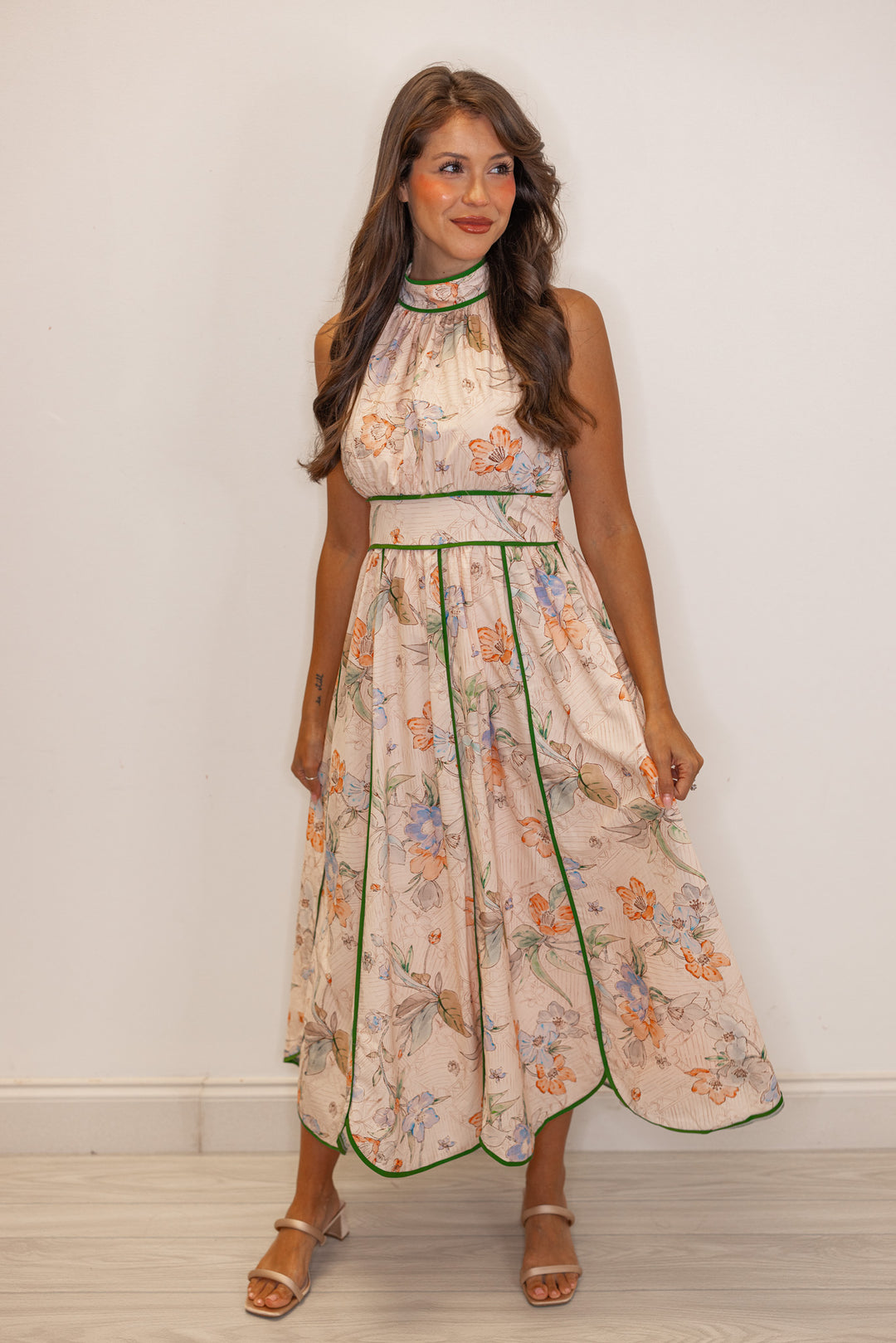 Women's blush floral print midi dress with green stripes and a tulip hem by Entro showing slight side view