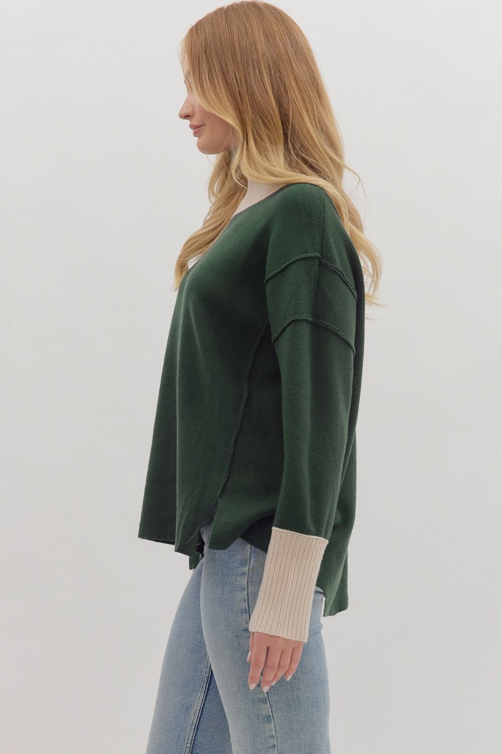 Women's hunter green sweater knit pullover top with cream ribbed trim by Entro showing side view