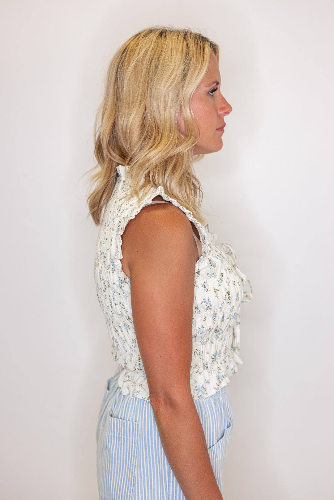 Women's cream and blue floral print smocked top with bow tie bodice by &merci showing side view