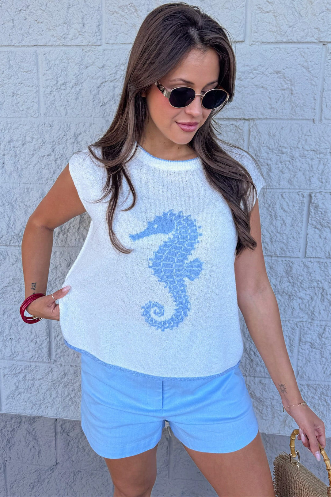 ivory with light blue seahorse detail rolled bottom hem sleeveless knit top