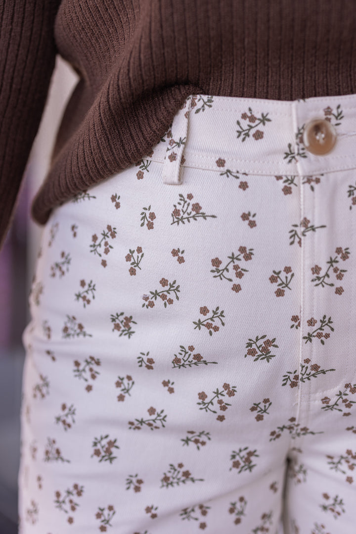 Women's cream denim pants with mocha and olive floral print by Wishlist showing up close look at floral print