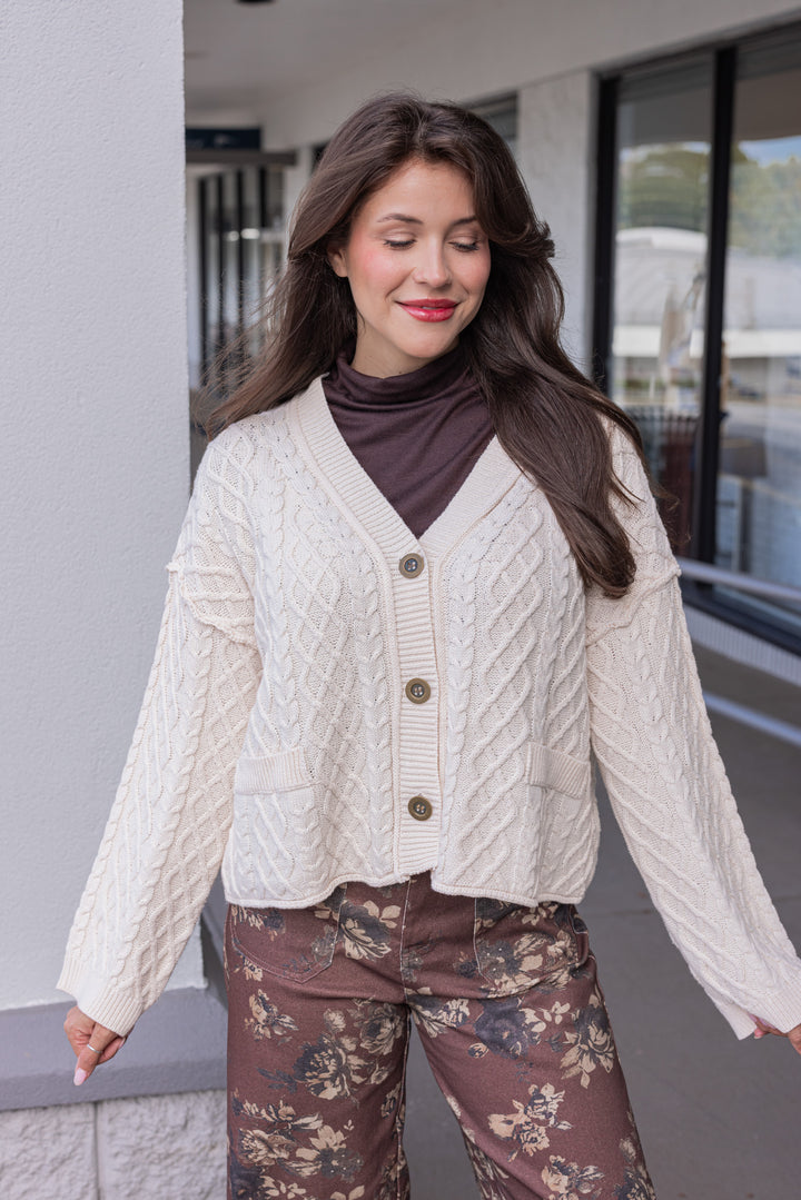 Women's cable knit button front sweater cardigan in ecru with ribbed trim by Entro