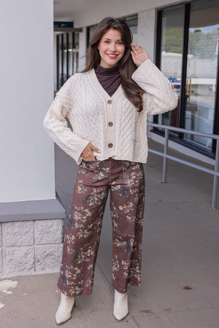 Women's cable knit button front sweater cardigan in ecru with ribbed trim by Entro showing full front view