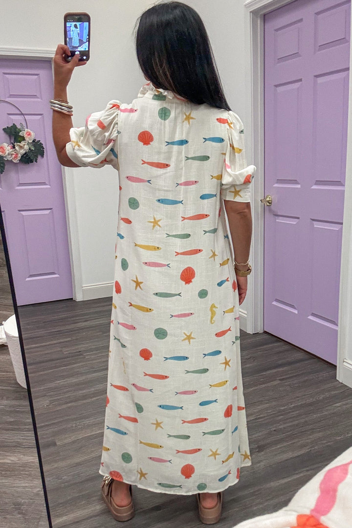 ivory with multicolored fish and seashell print short puff sleeve button front maxi dress