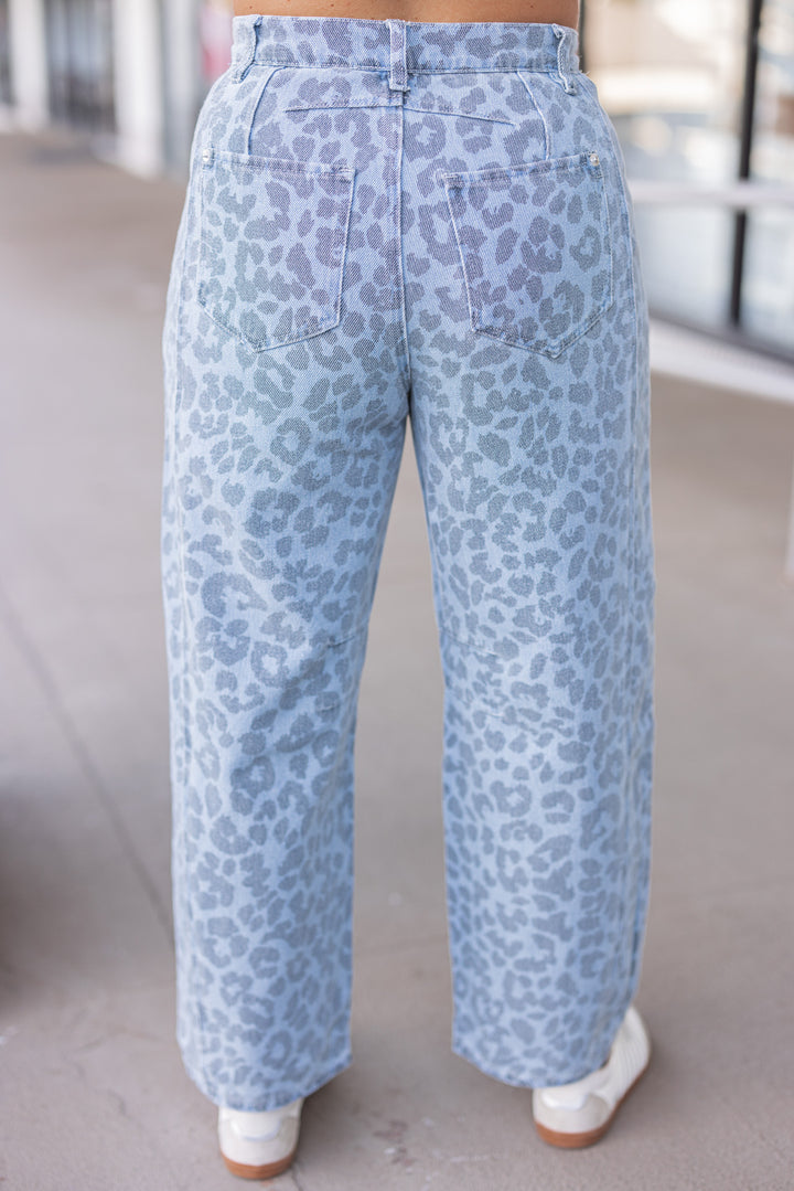 Washed blue and black leopard print barrel denim pants by Entro showing up close back view