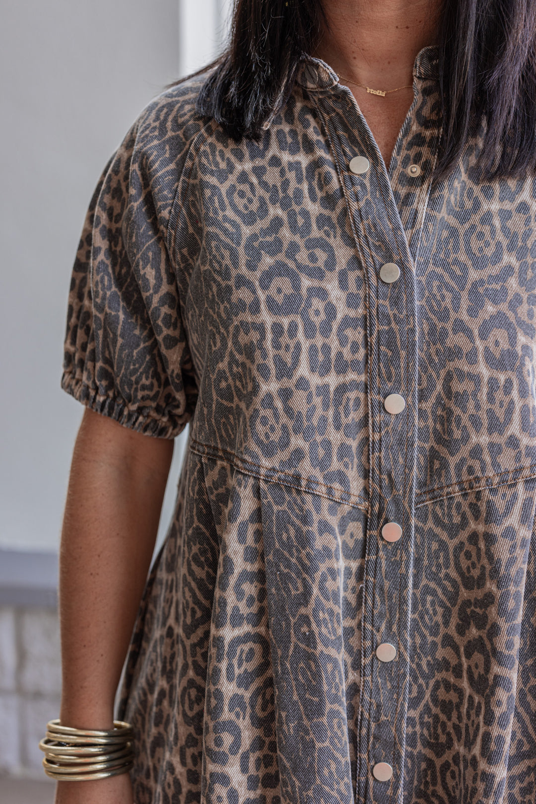 Brown and black washed denim animal print snap front dress with collar by Entro showing up close view of animal print detail