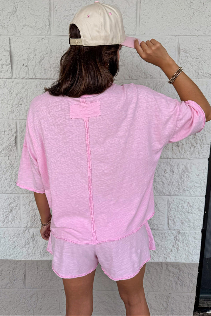 solid light pink raw seam short sleeve top and skort knit matching athleisure set