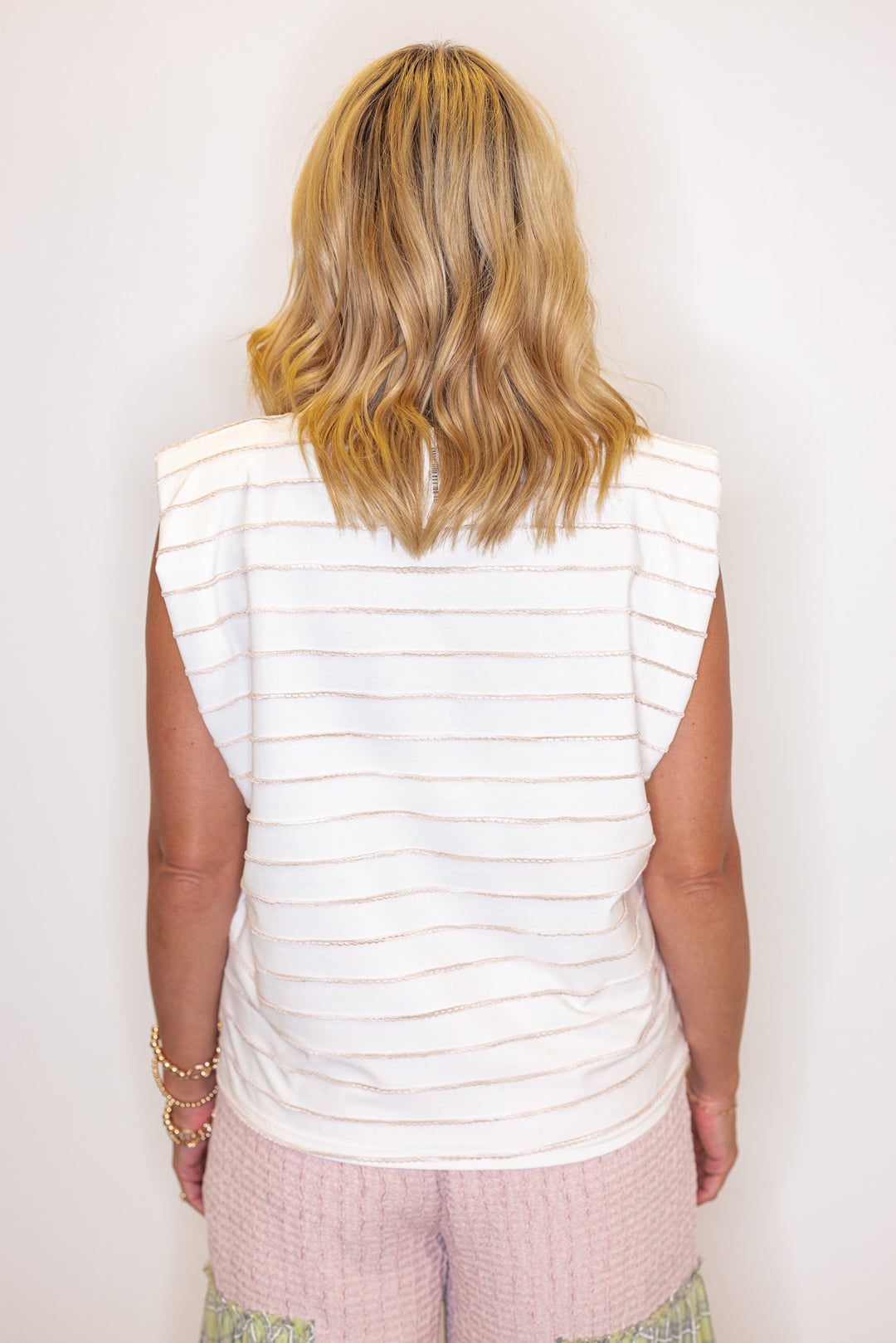Cream sleeveless knit top with ombre taupe textured wave stripes by Strut and Bolt showing back view