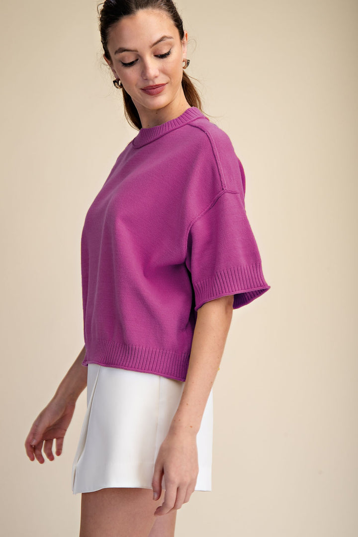 Magenta pink knit top with 1/2 length sleeves and a flattering fit