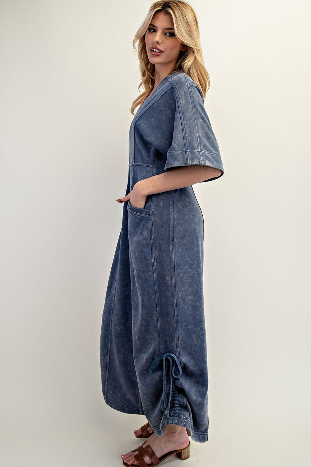 Women's knit jumpsuit in washed blue denim color with adjustable length by ee:some showing side view