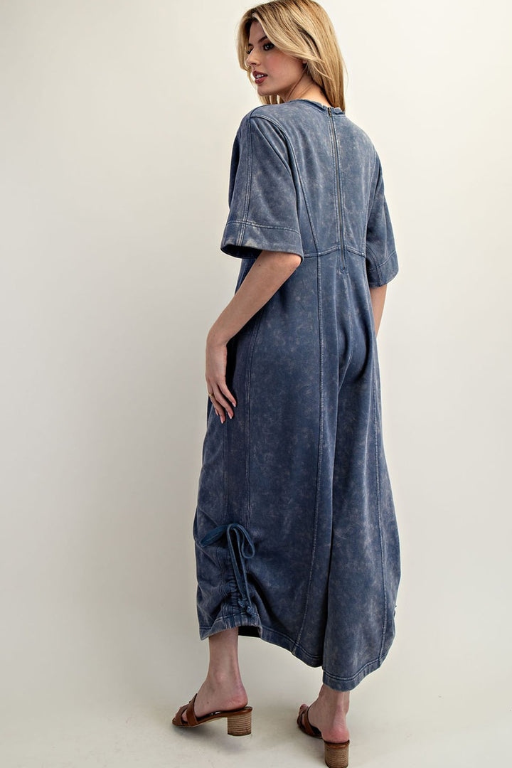 Women's knit jumpsuit in washed blue denim color with adjustable length by ee:some showing back view