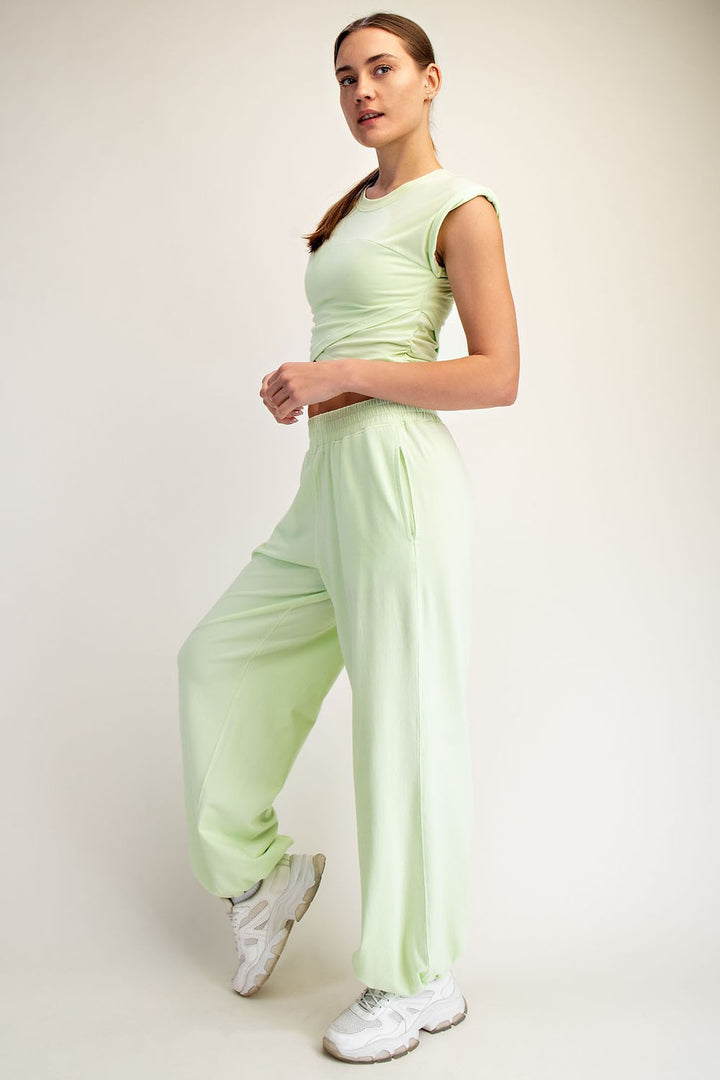 Mint sleeveless crosswaist crop top and matching jogger pants set by Rae Mode 