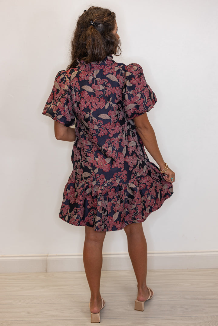 back view of Woman's burgundy and black floral printed dress