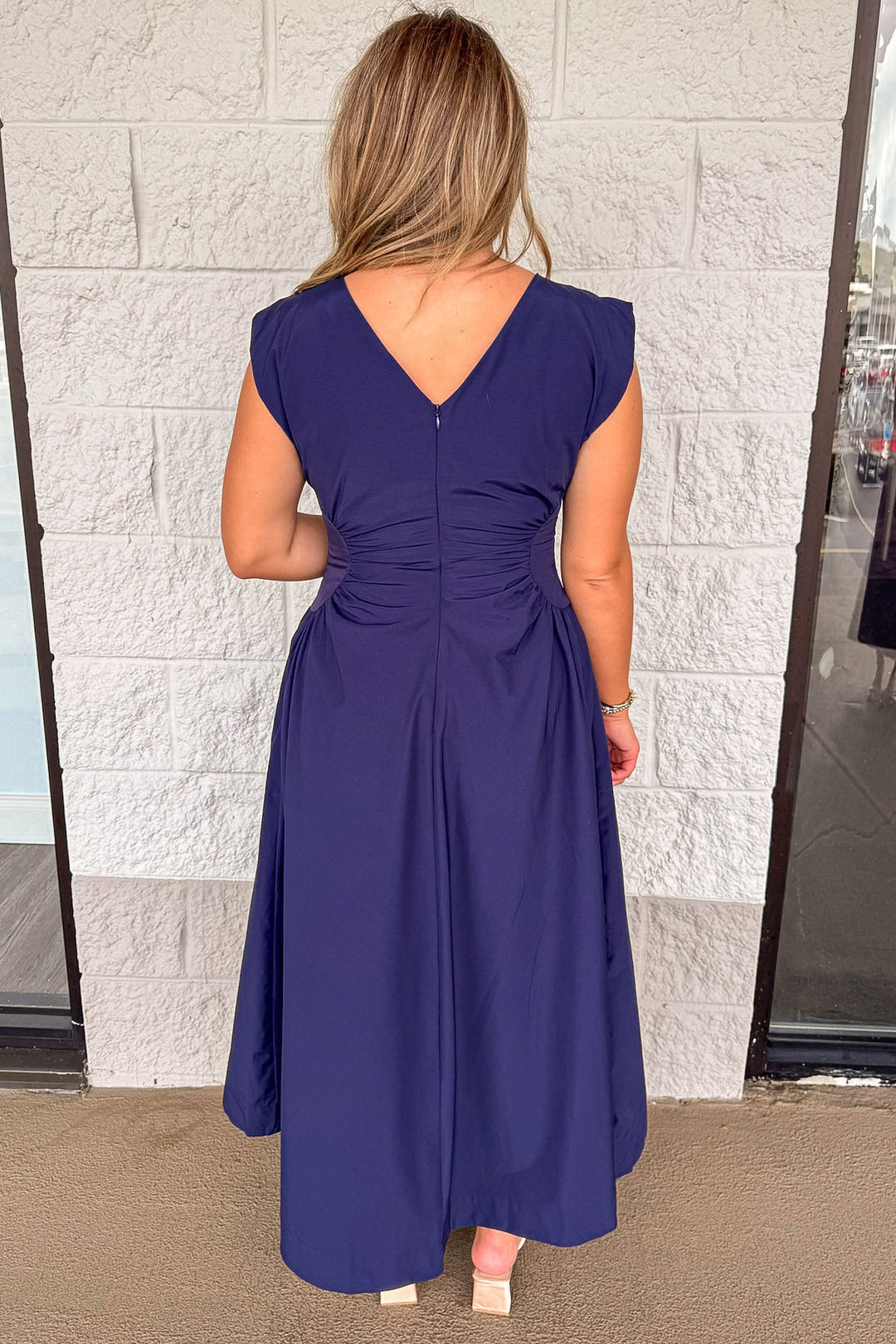 solid navy blue cinched waist sleeveless midi dress with hook and eye zipper closure