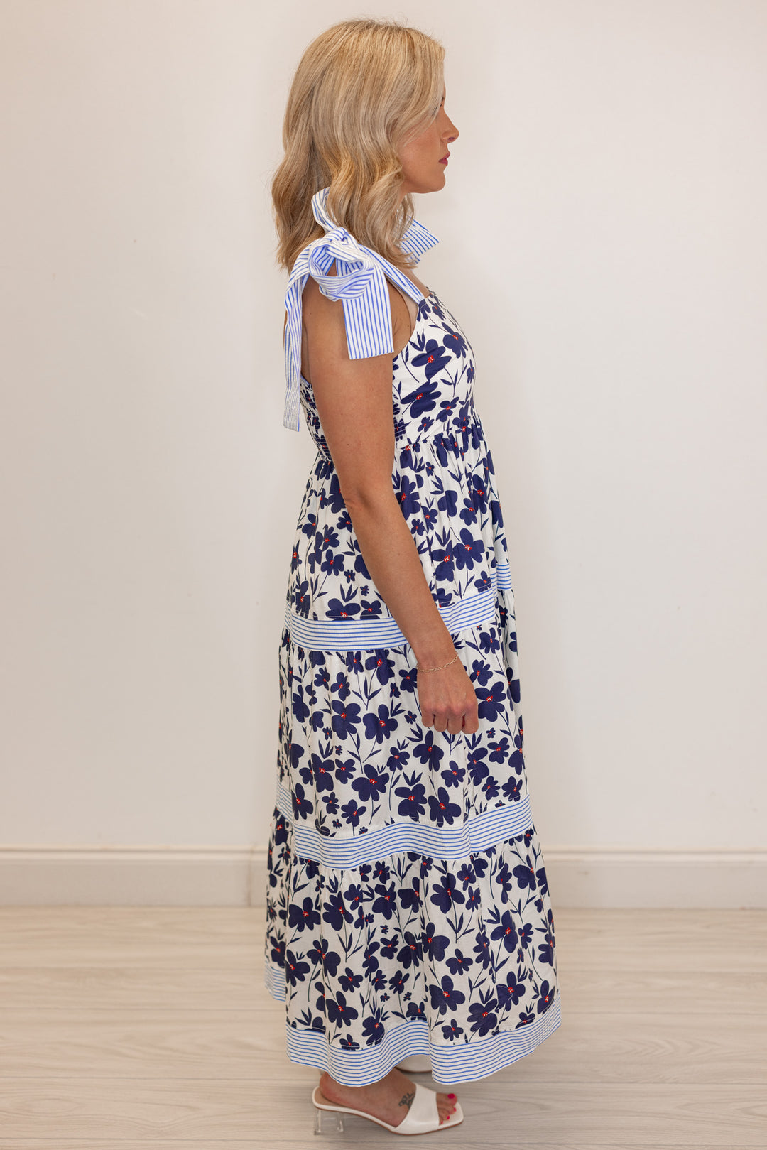 Women’s Navy blue floral print bridal shower midi dress, side view. 
