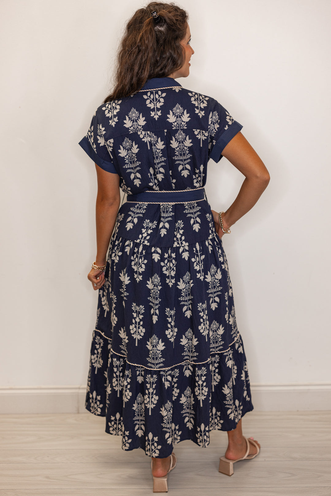 back view of Women's navy floral print belted midi dress