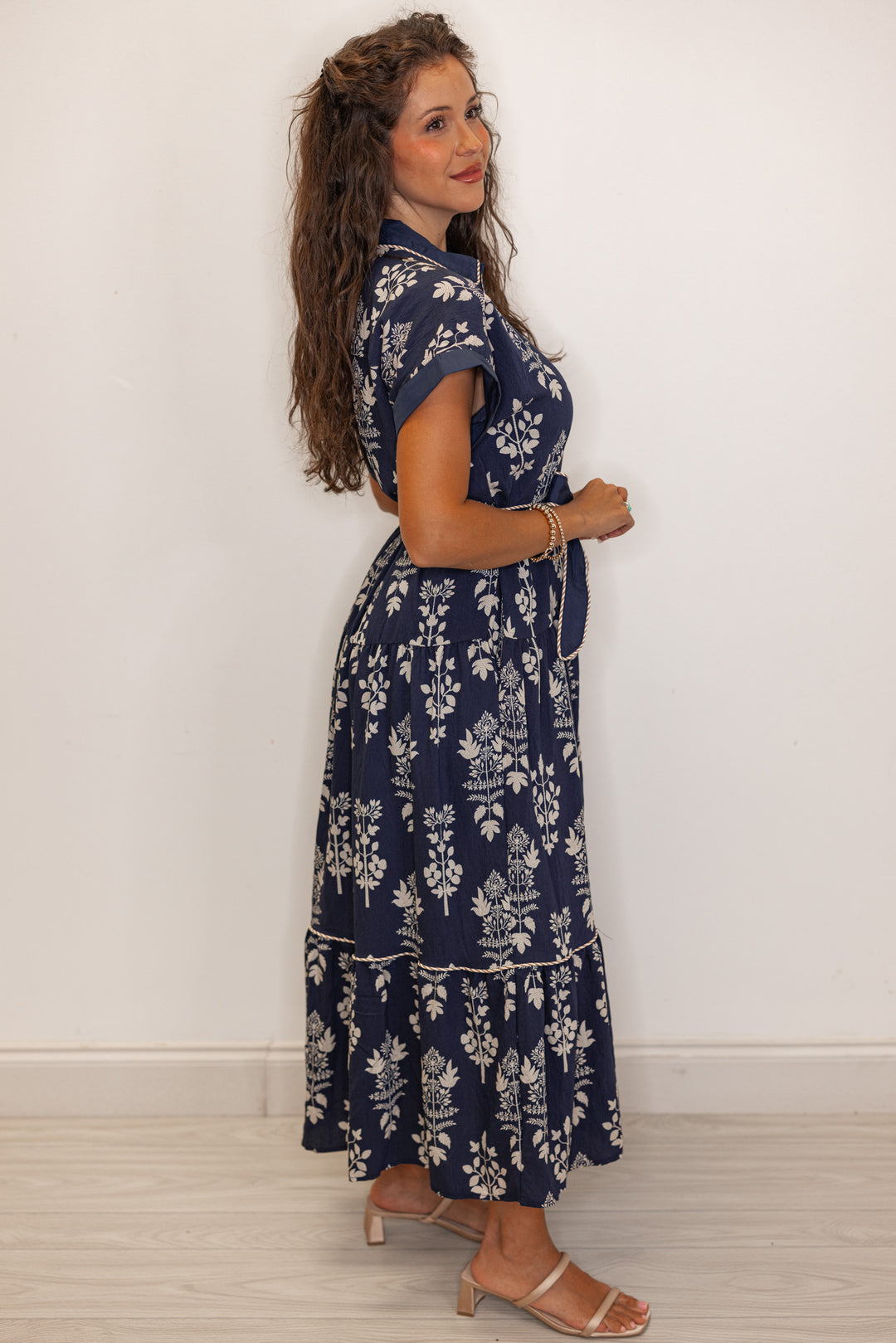 side view of Women's navy floral print belted midi dress