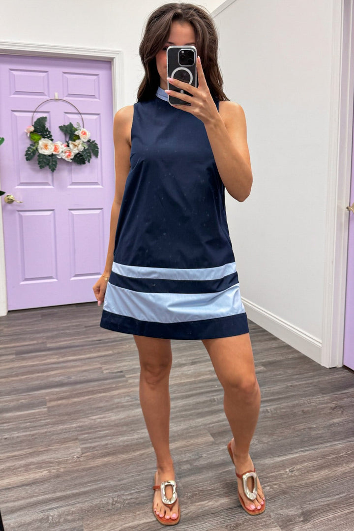 navy sleeveless mini dress with light blue banded trim detail and side pockets