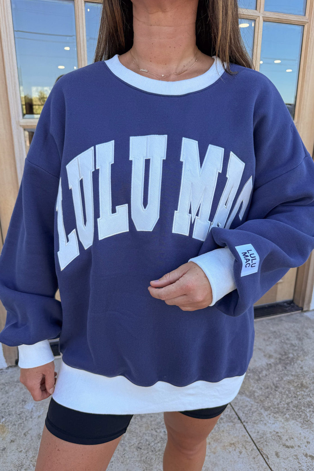 navy blue with white embroidered lulu mac and white trim long sleeve crew neckline sweatshirt