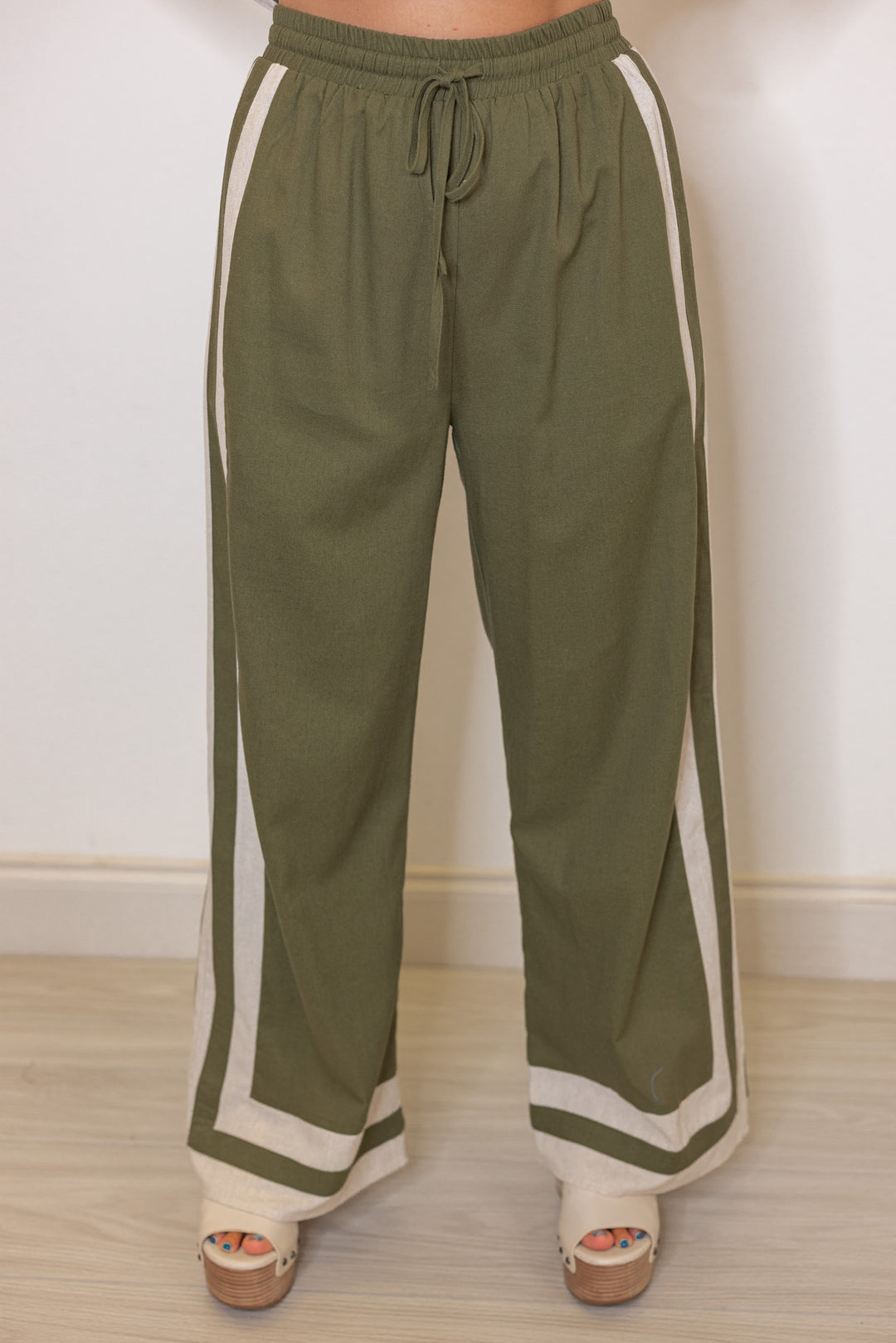 Women's olive green elastic waist linen pants with oatmeal trim throughout by Entro showing up close front view