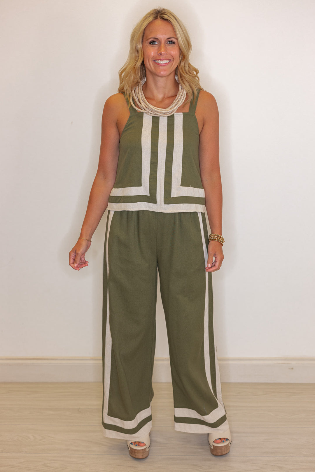 Women's olive green elastic waist linen pants with oatmeal trim throughout by Entro shown with matching top