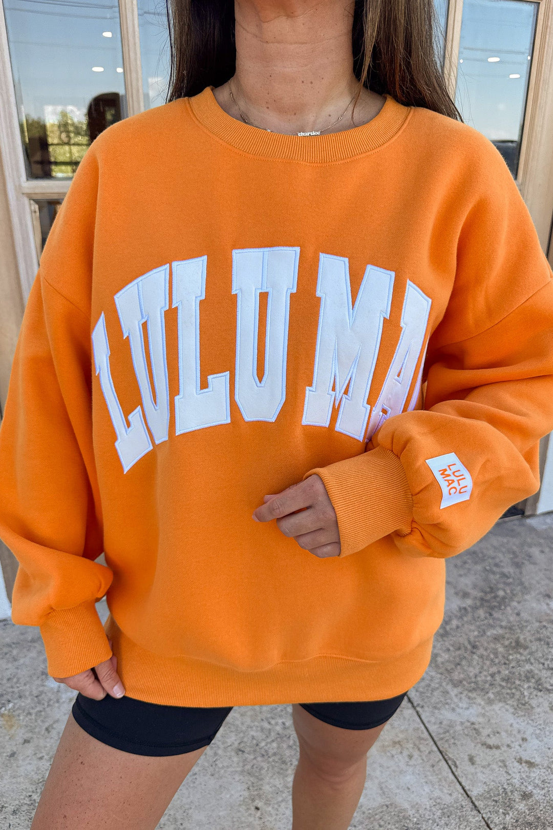 orange with white embroidered lulu mac long sleeve crew neckline sweatshirt