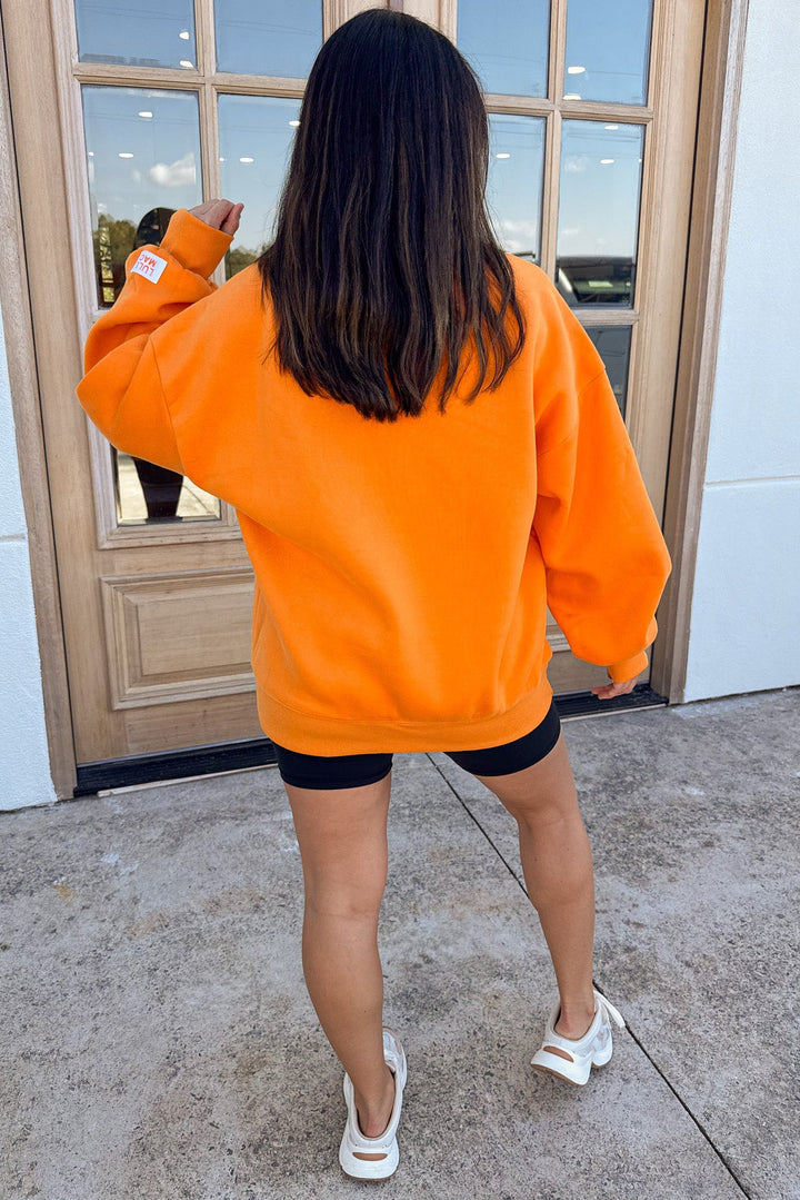 orange with white embroidered lulu mac long sleeve sweatshirt with banded bottom hem