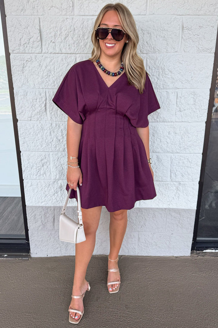 solid plum dolman sleeve v neckline pleated short dress with pintuck details down front and back