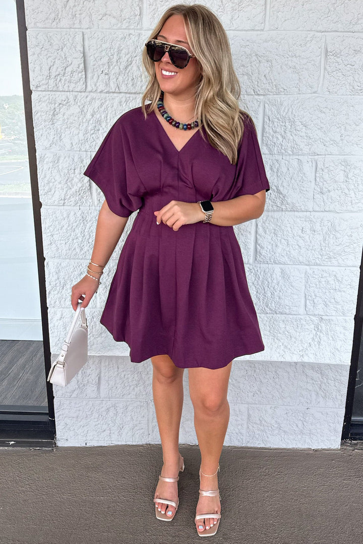 solid plum dolman sleeve v neckline pleated gathered waist short dress with pintuck details