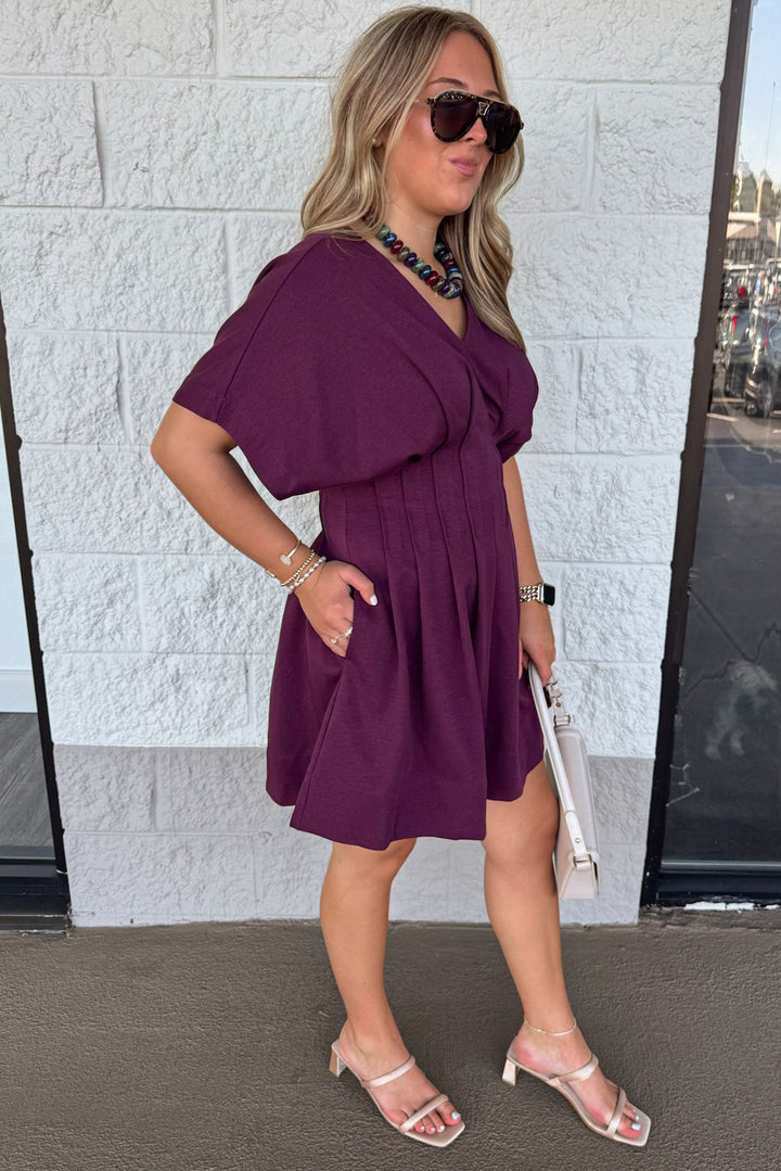 solid plum dolman sleeve v neckline pleated short dress with pintuck details and side pockets
