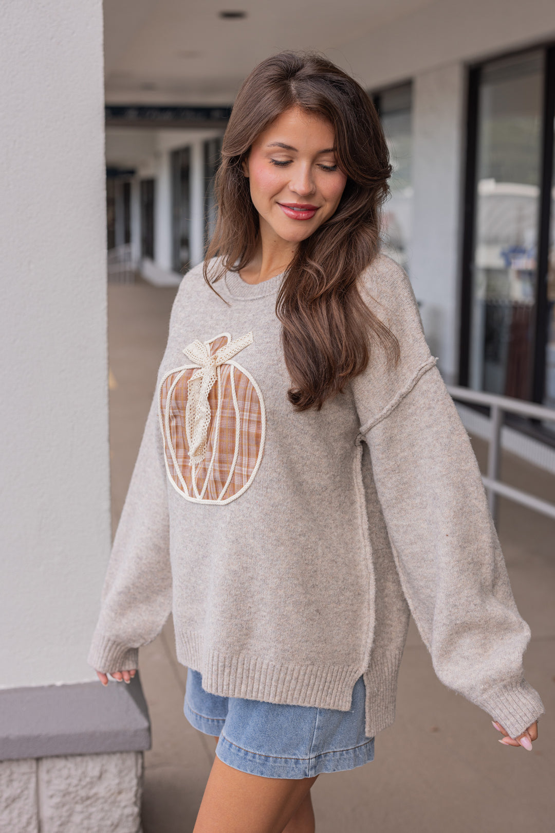 Women's grey knit sweater with a brown plaid pumpkin and cream lace detail on front by Fantastic Fawn showing up close side view