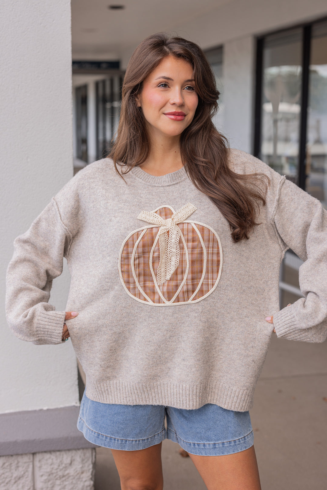 Women's grey knit sweater with a brown plaid pumpkin and cream lace detail on front by Fantastic Fawn showing oversized fit